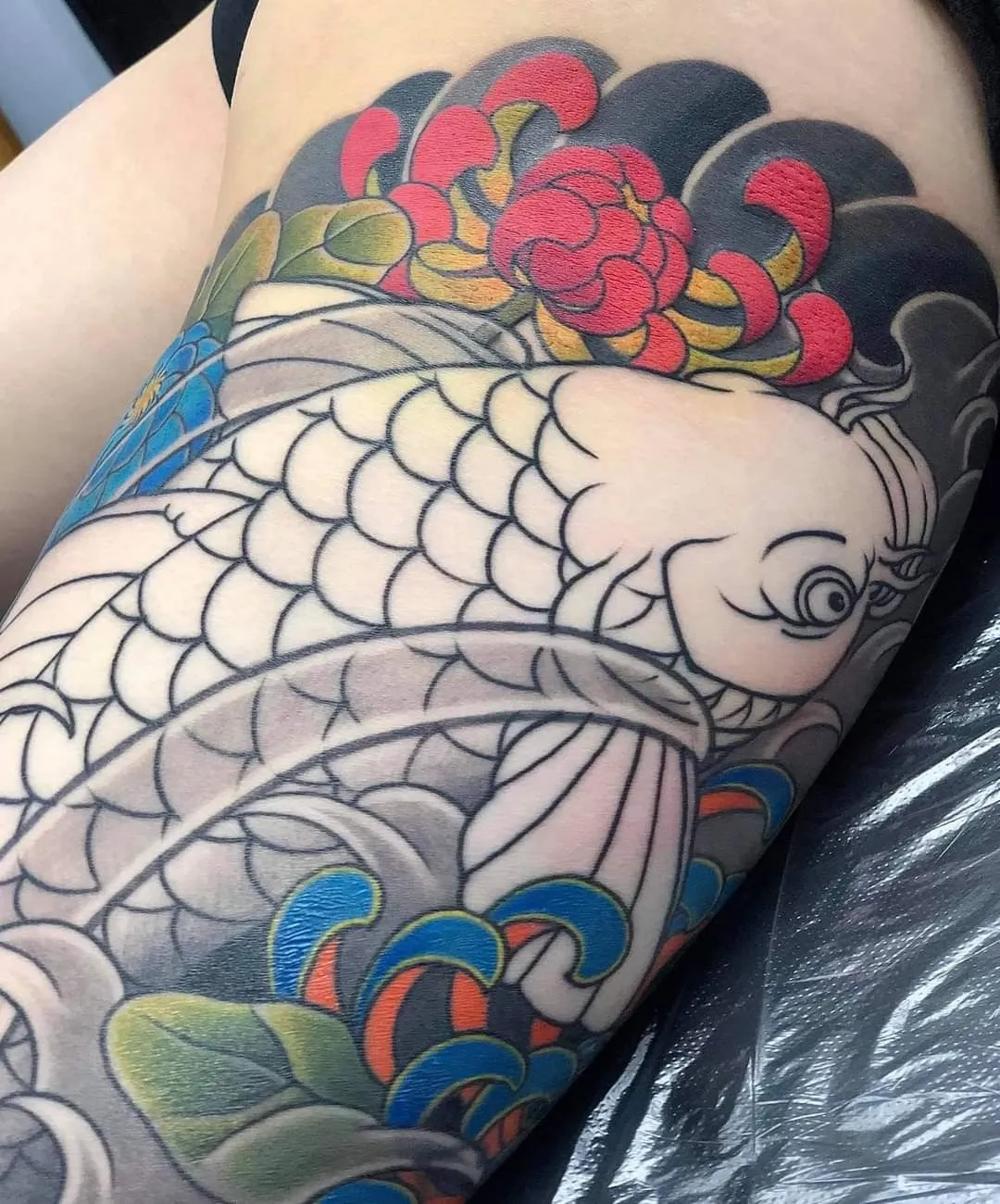 Collection of beautiful carp tattoos on the thighs leading the 2025 trend